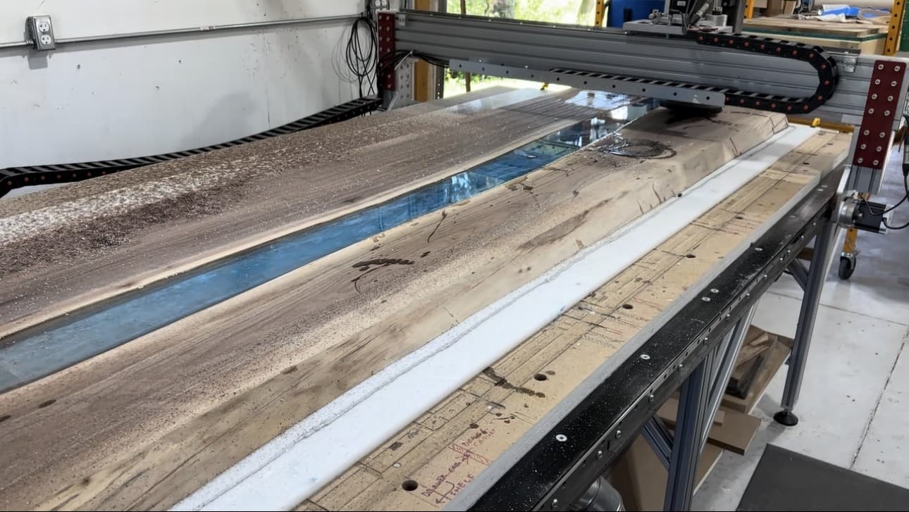 Craftsman using power tool on wood, sawdust flying