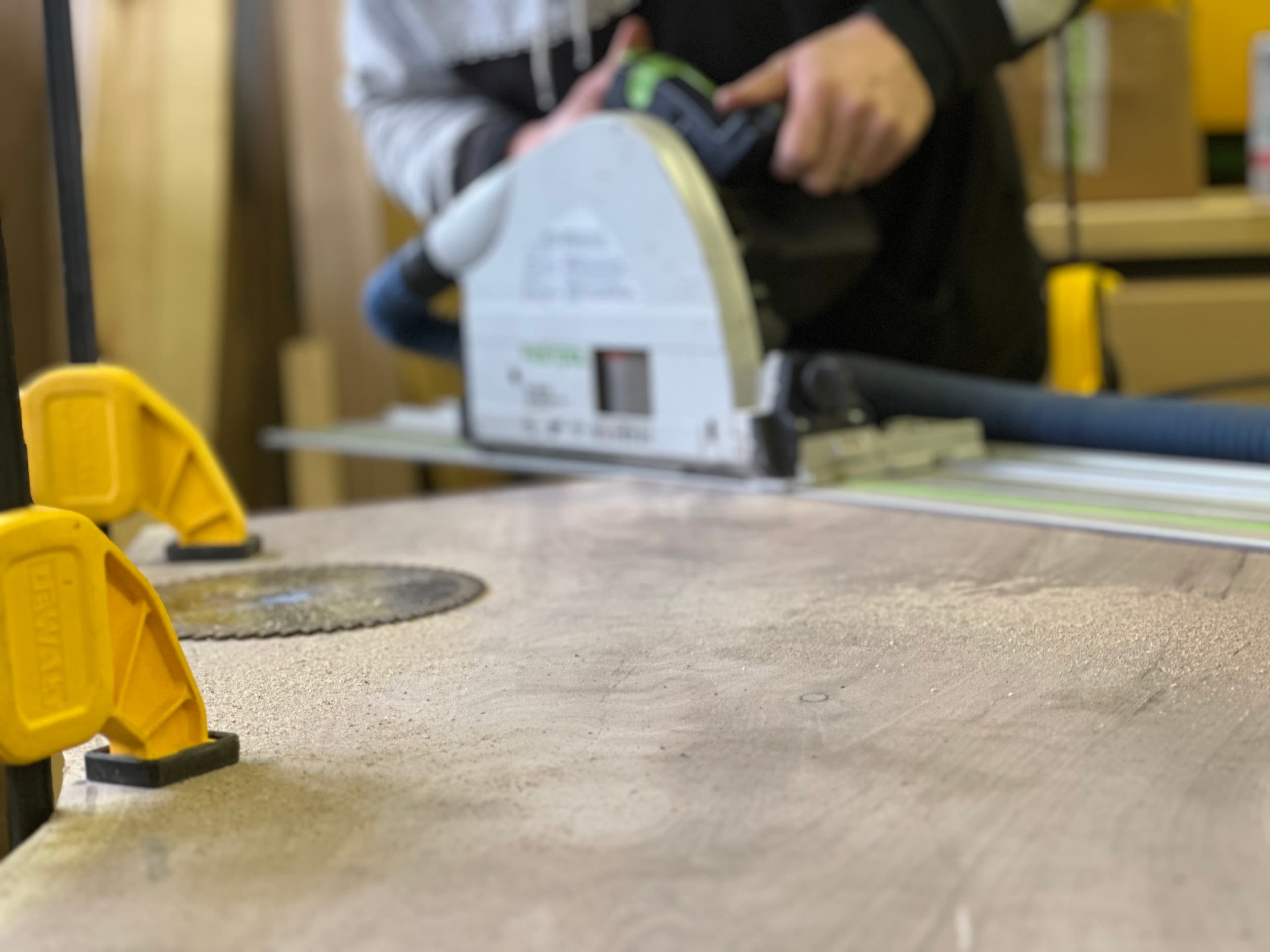 Craftsman sanding a wood surface with orbital sander